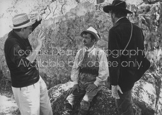 (L-R) Director Luchino Visconti rehearsing unidentified actor and Burt Lancaster (back to camera) during location shooting of the film "The Leopard."