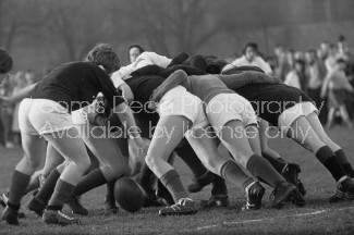 Girl's rugby team from Edinburgh University doing a scrum during a game.