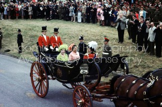 (L-R) Briatin's Queen Mother in green hat and dress and daughter Princess Margaret in peach hat and dress riding in a carriage on the occasion of Prince Charles' investiture.